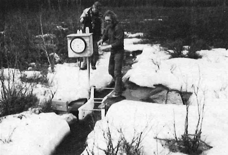 Technicians set up equipment for measuring breakup and early spring flow