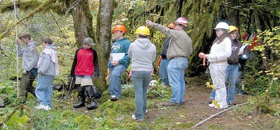 Kurt Cox (center, pointing) works with junior high school students