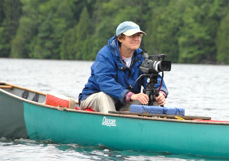Gail Osherenko filming loons at a pond in Vermont. Photo: Orah Moore.